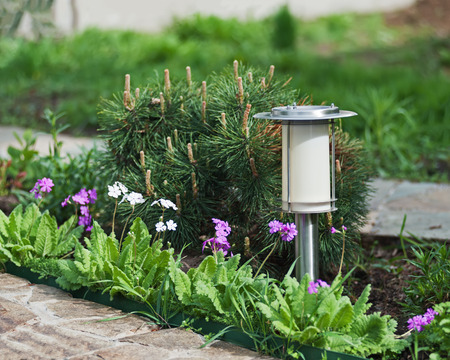Solar-powered lamp on garden background. Selective focus.の写真素材