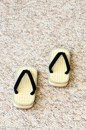 Pair of Traditional Japanese Sandals on Carpet Floor. Selective Focus.の写真素材