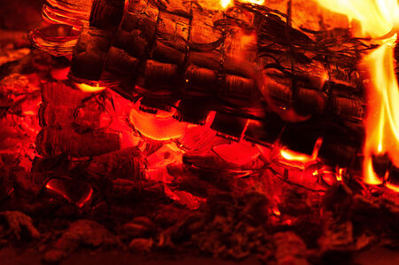 Fireplace burning. Warm burning and glowing fire in fireplace. Close up. Cozy background.の写真素材