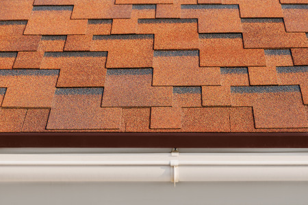 Bitumen asphalt shingles with plastic drainage on house roof.の写真素材