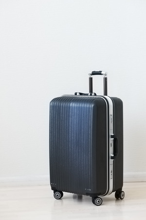 Large family polycarbonate luggage on white wooden background.の写真素材