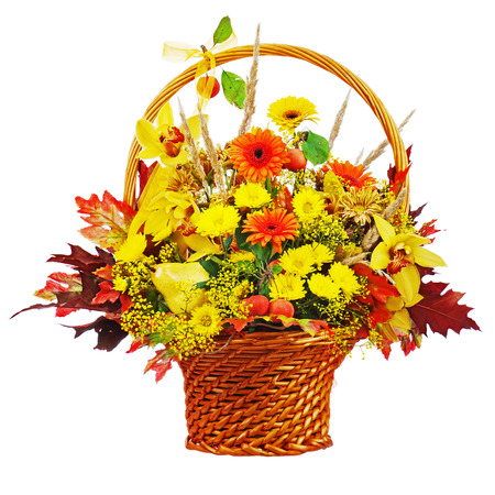 Colorful flower bouquet arrangement centerpiece in wicker basket isolated on white background. Closeup.の写真素材
