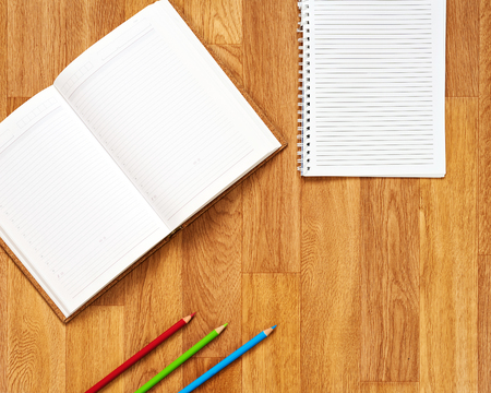 Blank notepad with office supplies on wooden table. Above view.の写真素材