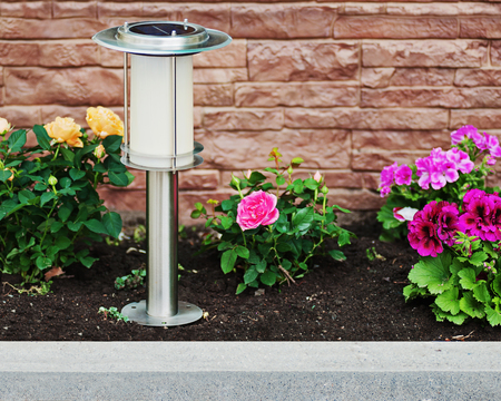 Solar-powered lamp on garden background. Selective focus.の写真素材