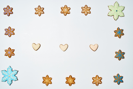 Gingerbread cookies on white background. Flat lay festive composition with copy space. New 2019 year holiday frame.の写真素材