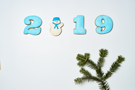 Gingerbread cookies on white background. Flat lay festive composition with copy space. New 2019 year holiday frame.の写真素材