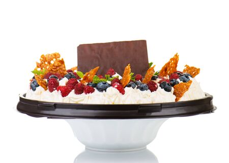 Delicious cake with fresh strawberries, raspberries, currants, blueberry and chocolate isolated on white background. の写真素材