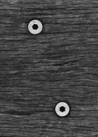 A black and white wood grain texture with 2 hex head screws in a minimalist style