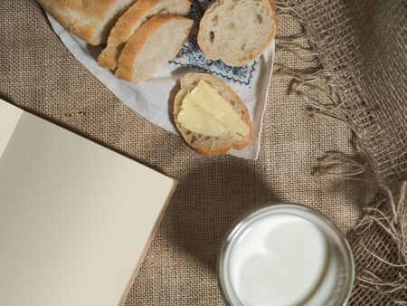 Breakfast at dawn in the village with milk, bread and book.の写真素材