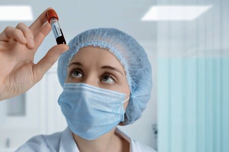 Scientist analyses test tube with blood sample in laboratory. MERS