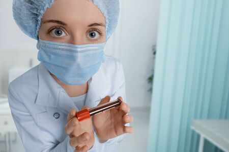 Doctor in hospital with blood sample and scared look. New epidemic Coronavirus 2019-nCoV,の写真素材