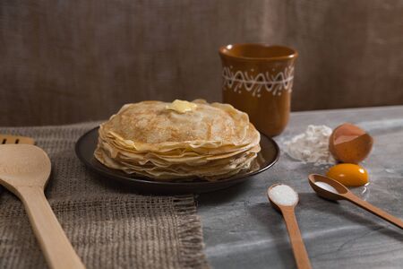 Cooking pancakes for Maslenitsa breakfast. A stack of pancakes with ingredients.の写真素材