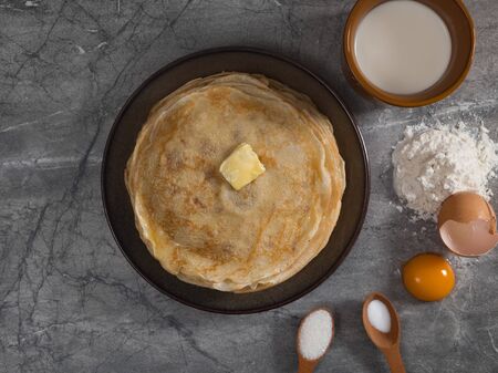 Cooking pancakes for Maslenitsa breakfast. A stack of pancakes with ingredients.の写真素材