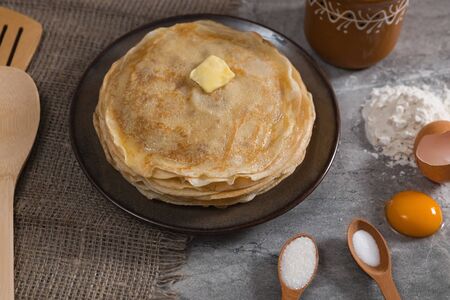 A stack of pancakes and pancake ingredients on the marble table. Holiday breakfast.の写真素材