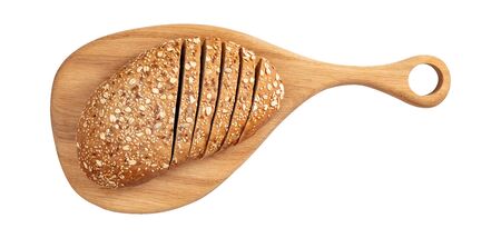 Isolated sliced bread with seeds and flakes on wooden cutting board on white background top view.の写真素材