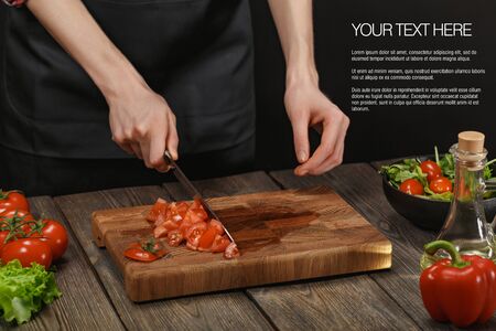 Woman cooking fresh healthy salad. Female hands cutting vegetables on board on wooden table. Diet concept for healthy lifestyle.の写真素材
