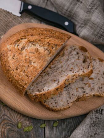Sliced bread and knife on wooden table. Rustic breakfast in the country.の写真素材