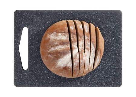 Isolated sliced bread on grey cutting board on white background top view.