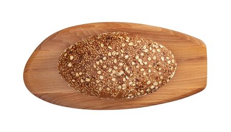 Isolated bread with seeds and flakes on wooden cutting board on whiteの写真素材
