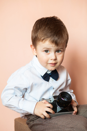 Little boy with aged retro camera. Young photographer. Child with an old cameraの写真素材