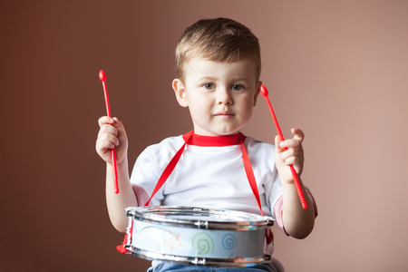 Little boy playing the drum. Lovely baby boy. Child development concept.の写真素材