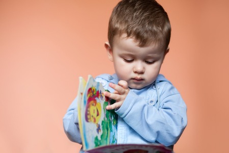 Portrait little boy with a book. Cute boy study and reading bookの写真素材
