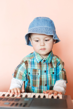 Little Cut Boy playing the digital piano. Happy childhood and music. Musical instrument indoor.の写真素材