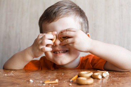 Cute little boy is playing with Bagelの写真素材