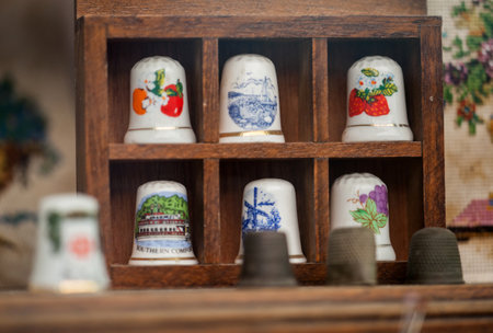 Fragment of shop window with sewing accessories. LVIV, UKRAINE - SEPTEMBER 24, 2018. Ceramic thimbles for tailorsのeditorial素材