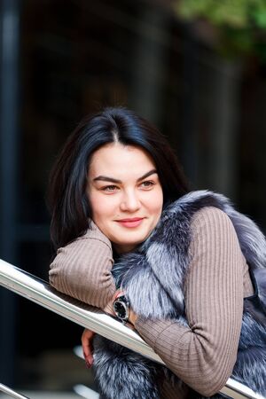 Stylish woman walking In the city in Fur-Vest. Urban street style, fashion trend.の写真素材
