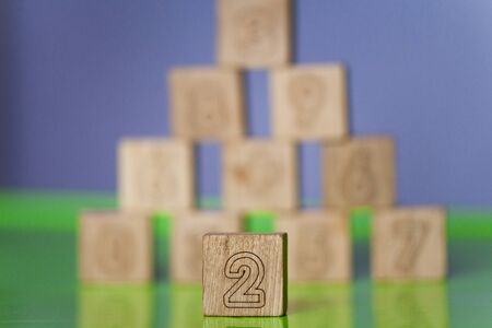 Arithmetic, mathematic, learning concept, numbers background with wooden cubes, copy space. Teaching a child of preschool age mathematicsの写真素材