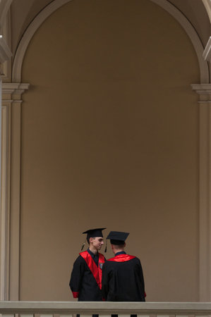 LVIV, UKRAINE - February 2, 2020: Two Students In Graduation Gown in Ivan Franko National University of Lviv. Friendly students in graduation gownsのeditorial素材