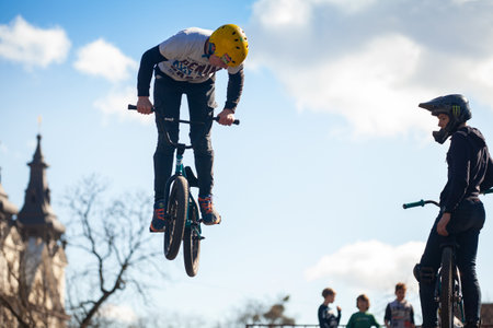 Lviv, Ukraine - March 12, 2020: Young man doing tricks on a BMX bike. Teenagers bikes at an urban biking and Skate parkのeditorial素材