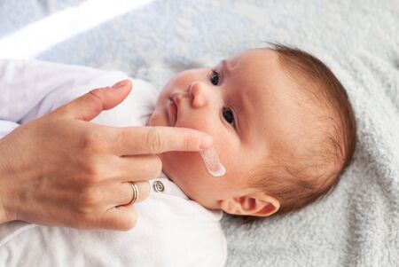 Baby with atopic dermatitis getting cream put. Care and Prevention Of Eczema. Keep Your Baby From Itchingの写真素材