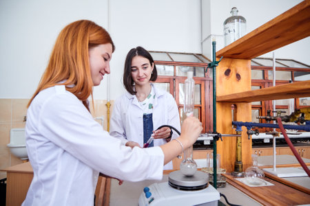 LVIV, UKRAINE - August 26, 2020: The Ivan Franko National University of Lviv. Girl students conducting scientific experiment in chemistry laboratory classroom. Young students conduct experiments in university in laboratoryのeditorial素材