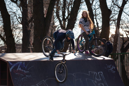 Lviv, Ukraine - March 12, 2020: BMX in the city skatepark. A group of teens on Bmx bikes in a skate park. Extreme sports is very popular among youth.のeditorial素材