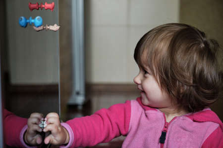 Little girl playing stickies toys. Cute little girl playing with toys at home