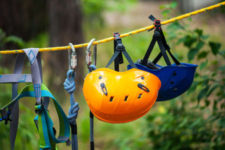 Safety helmets in adventure park. Tourist summer time adventure park family and company team building concept for extreme recreation sports.の写真素材