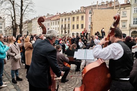 Lviv, Ukraine - March 16, 2022: Symphony Orchestra performed on Market Square in Lviv as part of the Free Sky art campaign in support of the call to close the sky over Ukraineのeditorial素材