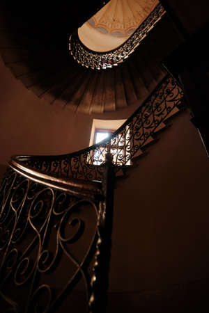Beautiful wrought iron stairs in old house in Lviv, Ukraine. View from belowの写真素材