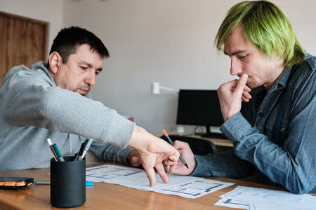 Team of two colleagues interior designers working on architectural project in office. Teamwork, Business Communication.の写真素材