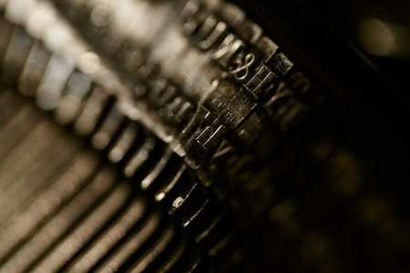 Closeup of old typewriter plates strikers strykers with letters and symbols for typing. Shallow...
