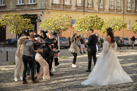 Lviv, Ukraine - October 28, 2022: Wedding Photography Masterclass. Young Attractive Marriage Couple Posing In The Old Town. Photographers shoot the bride and groomのeditorial素材