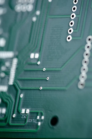 Macro shot of the back side of a circuit board. Close up of a printed green computer circuit board....