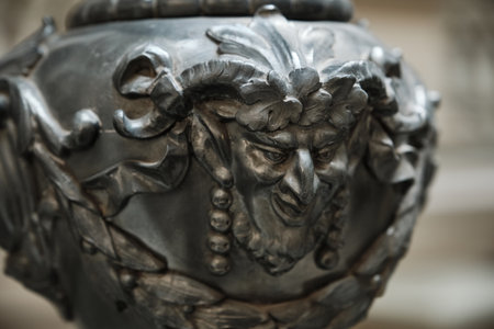 Ornate Metal Mask of a Mythological Satyr or Faun. Close-up highlighting the intricate details and expressive features of the sculpted face.の写真素材