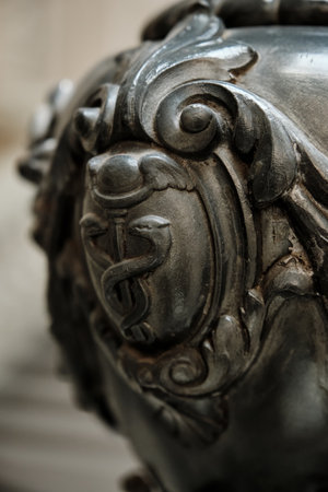 Close-up of an Ornate Metal Caduceus Emblem. Macro photograph emphasizing the intricate design of the traditional medical symbol. Emblem of Health and Medicine.の写真素材