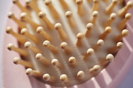Top view macro of wooden hairbrush pins creating a rhythmic pattern. Abstract background of bamboo...