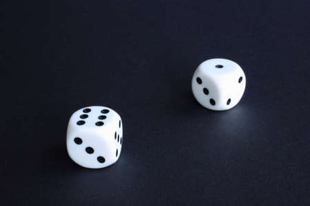 Two white dices on blackの写真素材
