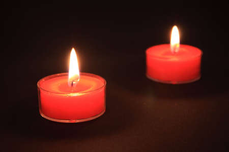 Two red candles on blackの写真素材