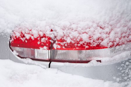 The rear light of a snow covered carの写真素材